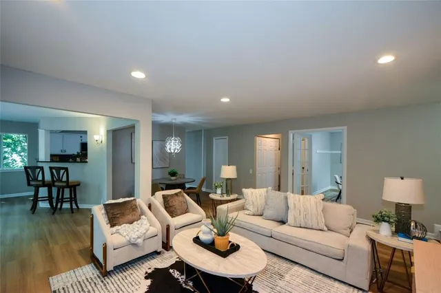 a living room with furniture and a wooden floor