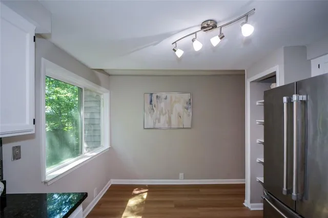 a view of room with window and wooden floor