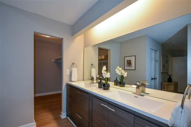 a bathroom with a sink a mirror and a shower