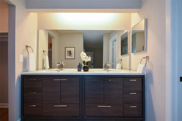 a bathroom with a sink vanity and mirror