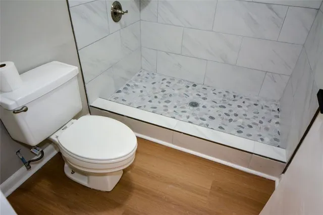 a bathroom with a toilet and a shower