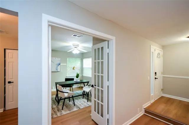 a view of a hallway with a livingroom and furniture