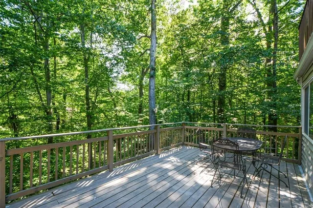a view of a balcony with wooden floor and fence