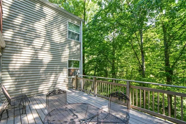 a view of a balcony with a floor to ceiling window and wooden fence