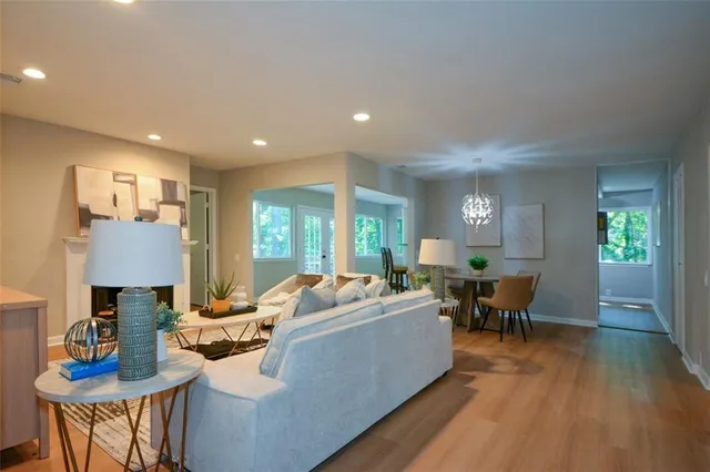 a living room with fireplace furniture and a wooden floor