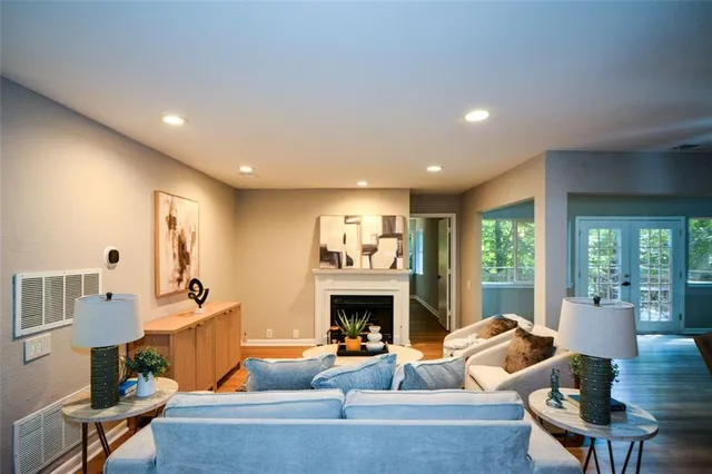 a living room with furniture a fireplace and a large window