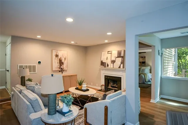 a living room with fireplace furniture and a wooden floor