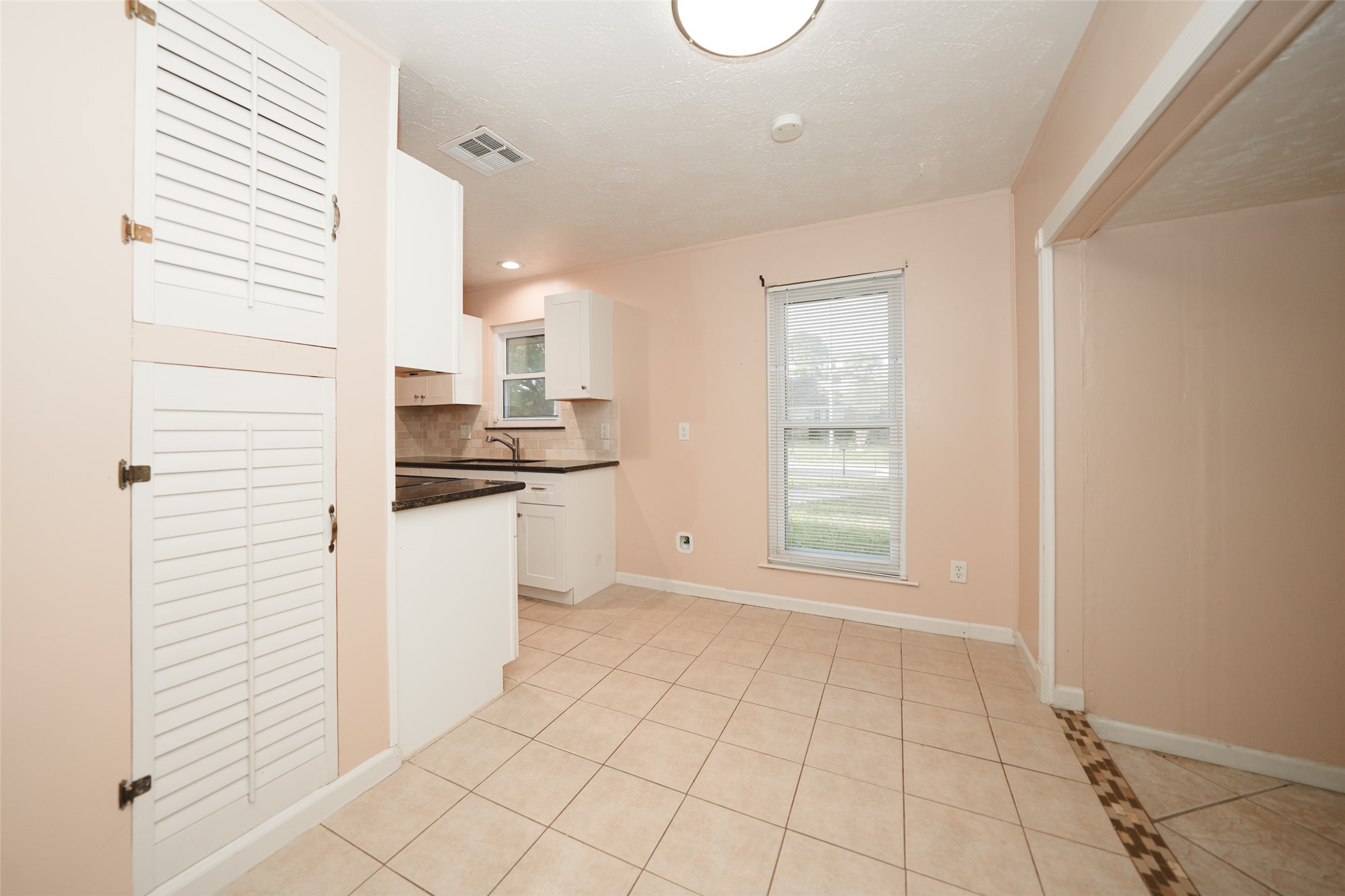 5227 Ridge Turn Drive Houston, TX 77053 - Photo 12 of 35 a kitchen with white cabinets and white appliances