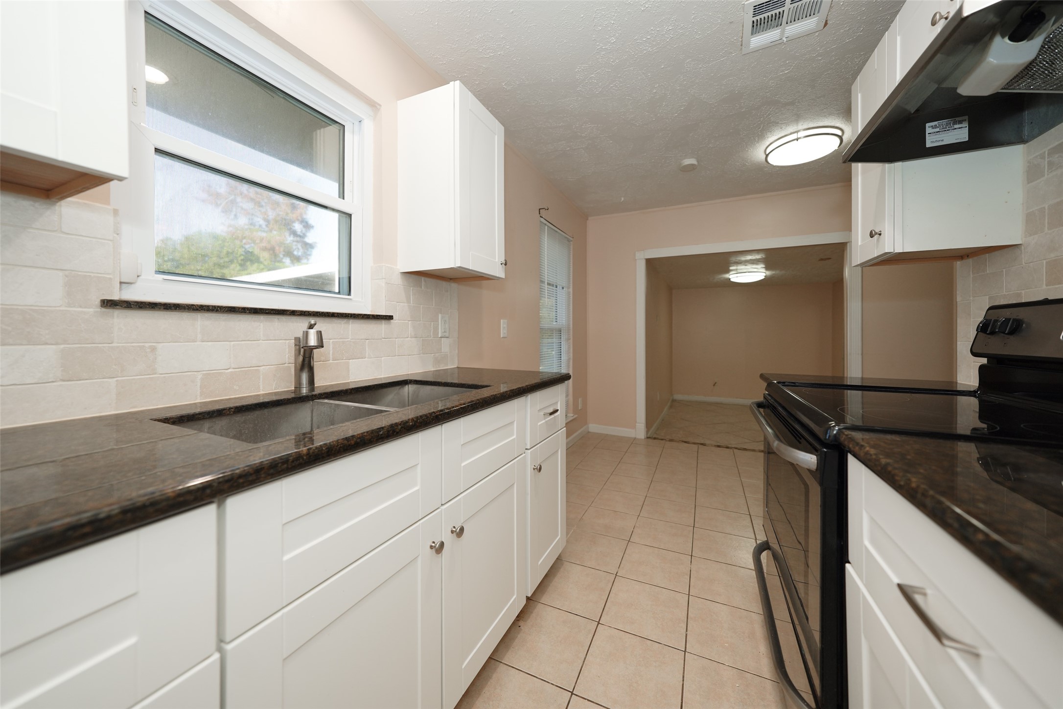 5227 Ridge Turn Drive Houston, TX 77053 - Photo 6 of 35 a kitchen with stainless steel appliances granite countertop a sink stove and cabinets