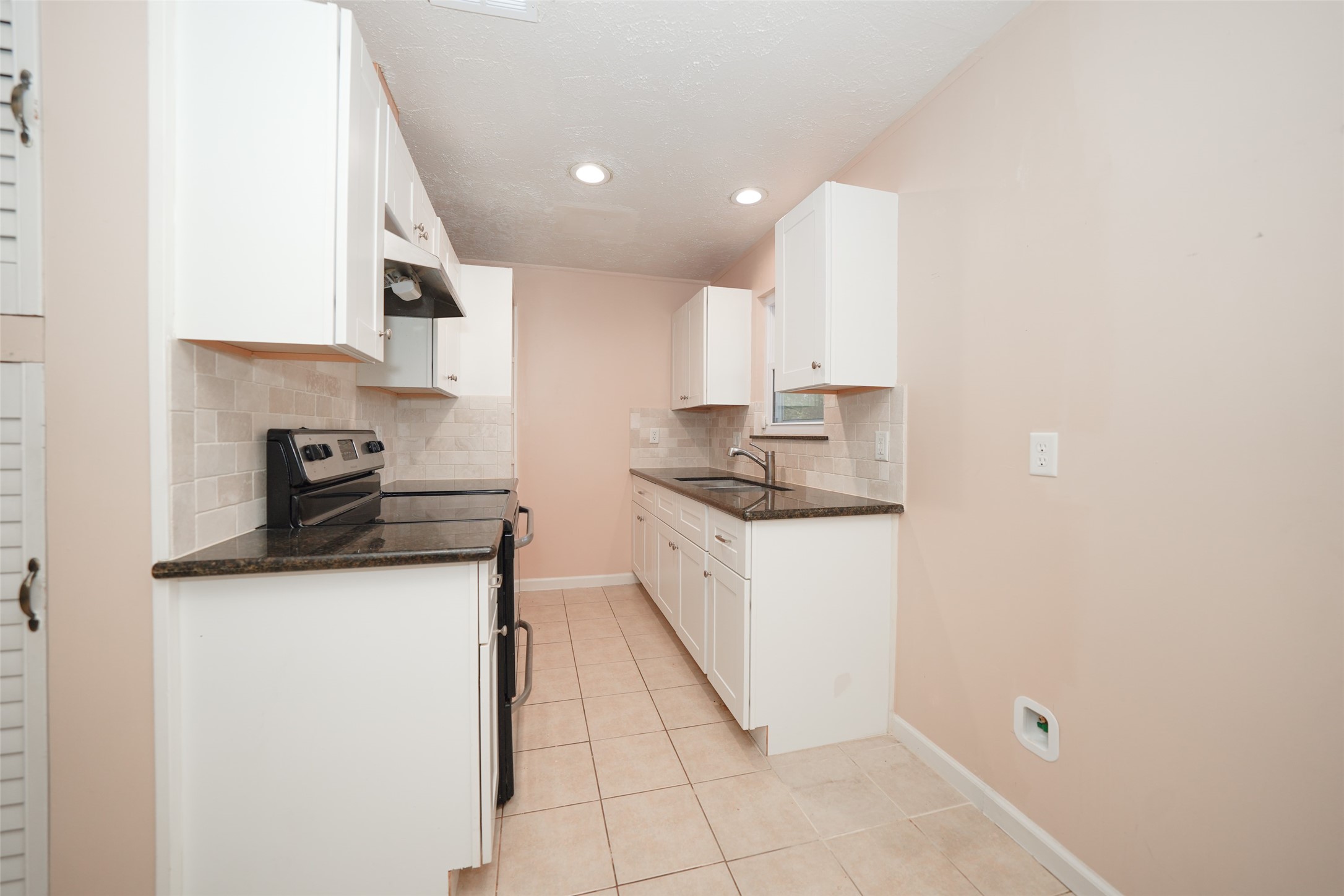 5227 Ridge Turn Drive Houston, TX 77053 - Photo 8 of 35 a kitchen with a sink a stove and cabinets