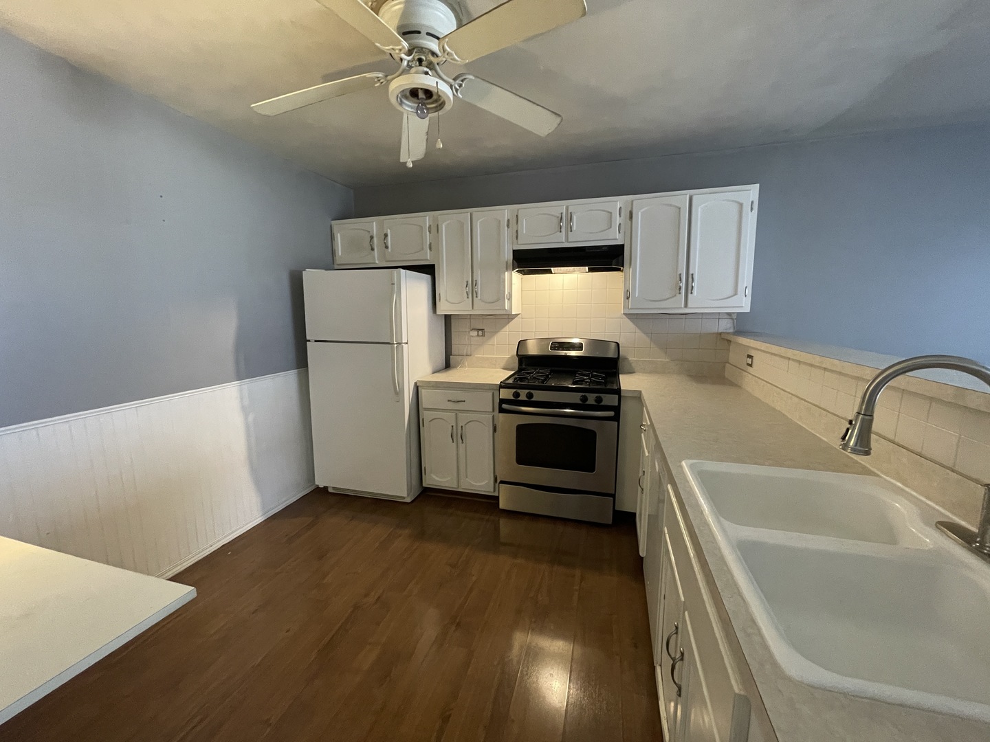 2061 Windward Lane Hanover Park, IL 60133 - Photo 5 of 15 a kitchen with a refrigerator sink and white cabinets