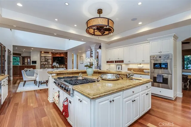 a kitchen with stainless steel appliances granite countertop sink stove and cabinets