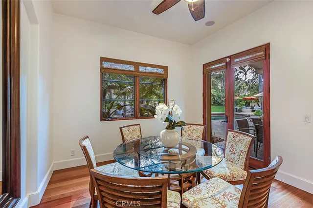a view of a lake with a bench and lawn chairs under an umbrella