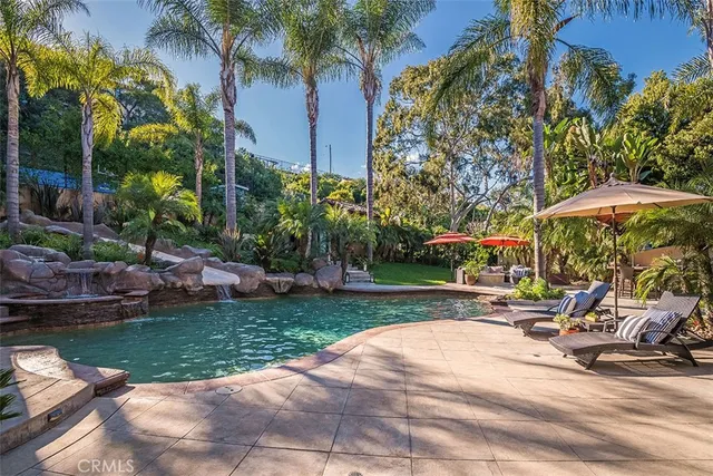 a view of a patio with a table and chairs under an umbrella