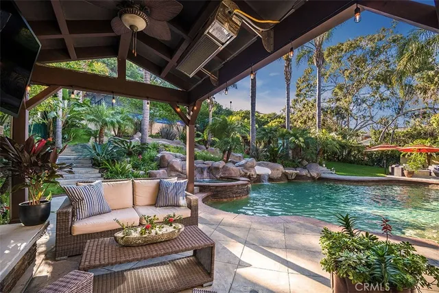a view of a house with backyard and sitting area