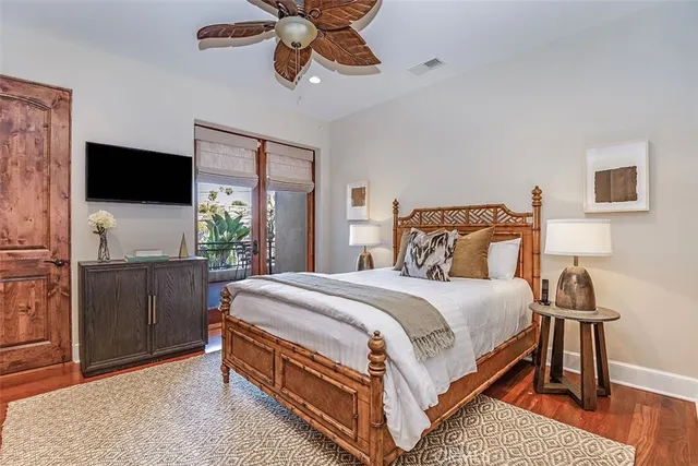 a living room with a bed furniture and paintings on the wall