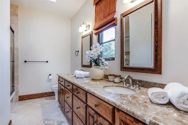 a living room with furniture potted plant and a large window