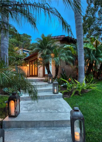 a backyard of a house with table and chairs