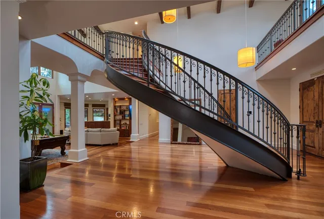 a living room with furniture a flat screen tv and kitchen view