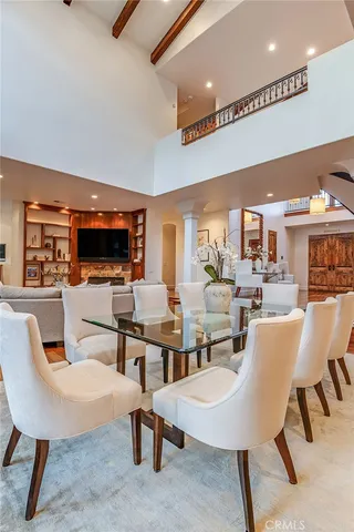 a dining room with furniture a rug and wooden floor
