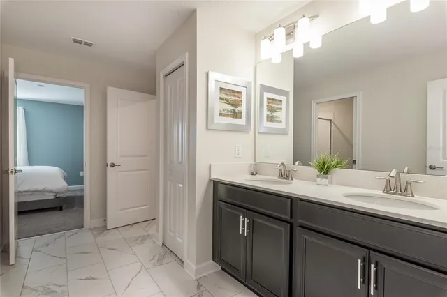 a en suite bathroom with a sink double vanity and a mirror