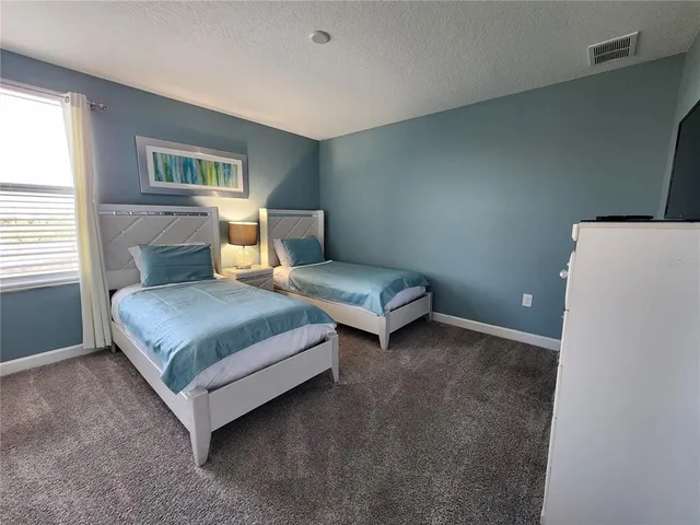 a bedroom with a bed and a table in it