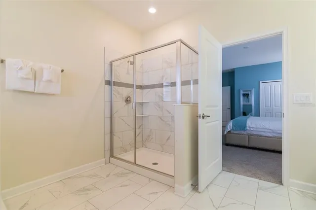 a bathroom with a shower and closet