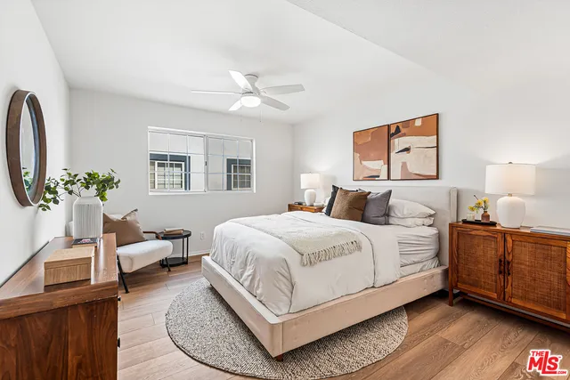 a bathroom with a granite countertop double vanity sink and a mirror