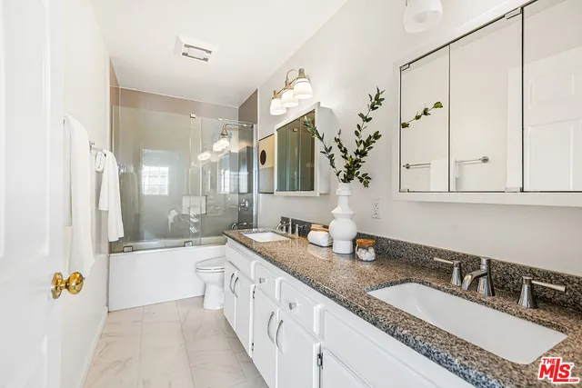 a bedroom with bed and a chandelier