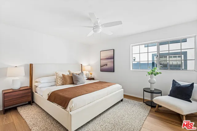 a bedroom that has a bed and a chandelier