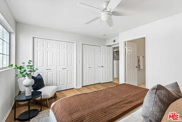 a bathroom with a granite countertop sink mirror vanity and toilet