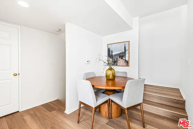 a dining room with furniture and wooden floor