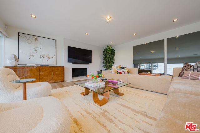 a living room with fireplace furniture and a flat screen tv