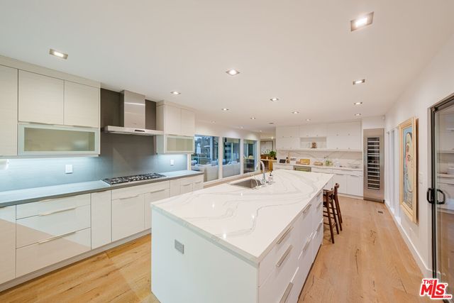 a kitchen with a sink and chairs