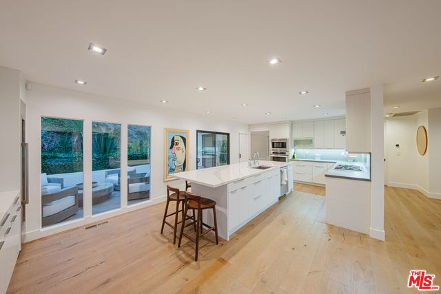 a large kitchen with a table and chairs