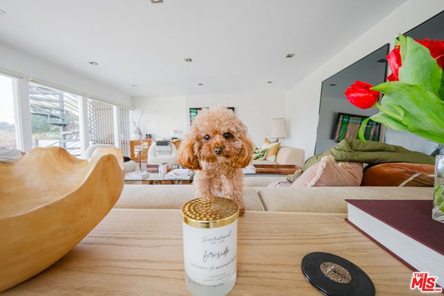 a bedroom with furniture and a flat screen tv