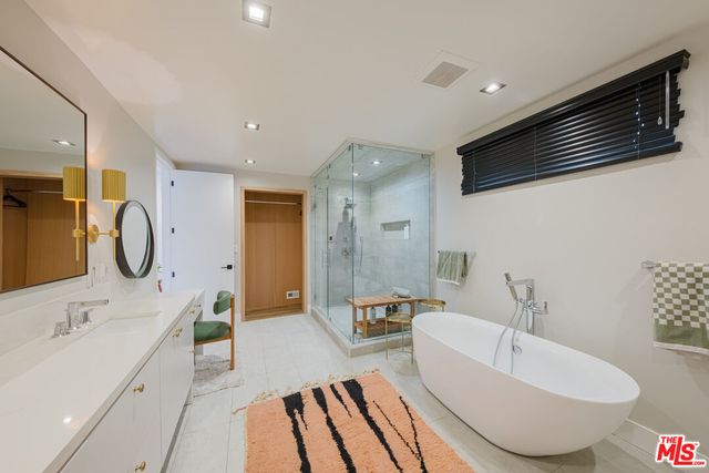 a bathroom with a bathtub and shower