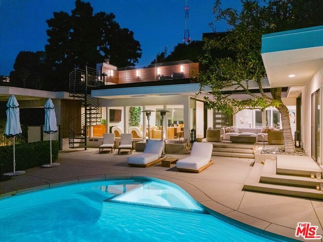 a view of a patio with dining table and chairs with wooden floor and fence