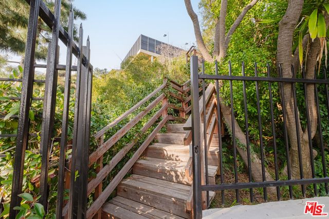 a bedroom with furniture and large windows