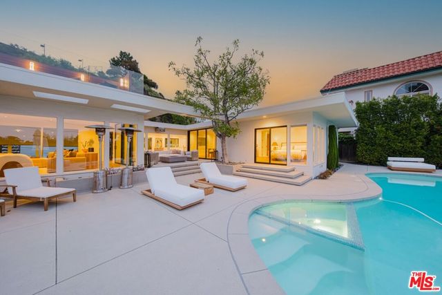 a bedroom with furniture and large windows