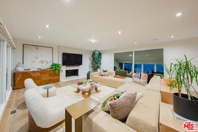 a living room with fireplace furniture and a flat screen tv