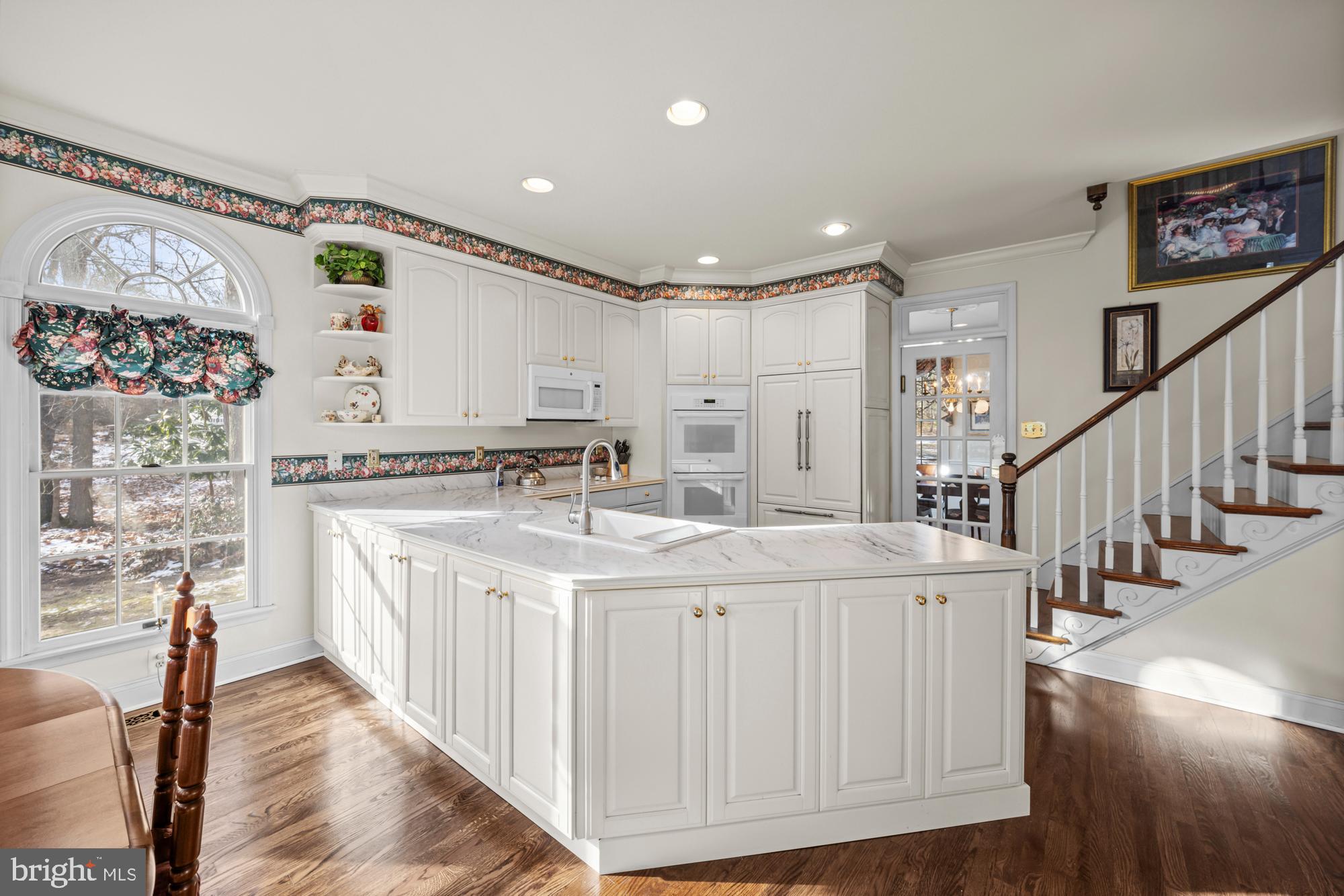 4 Independence Way Southampton, NJ 08088 - Photo 11 of 25 a large white kitchen with a sink and cabinets