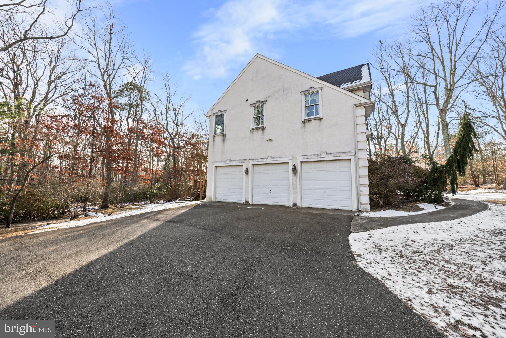 4 Independence Way Southampton, NJ 08088 - Photo 23 of 25 a view of a white house with a yard covered in snow