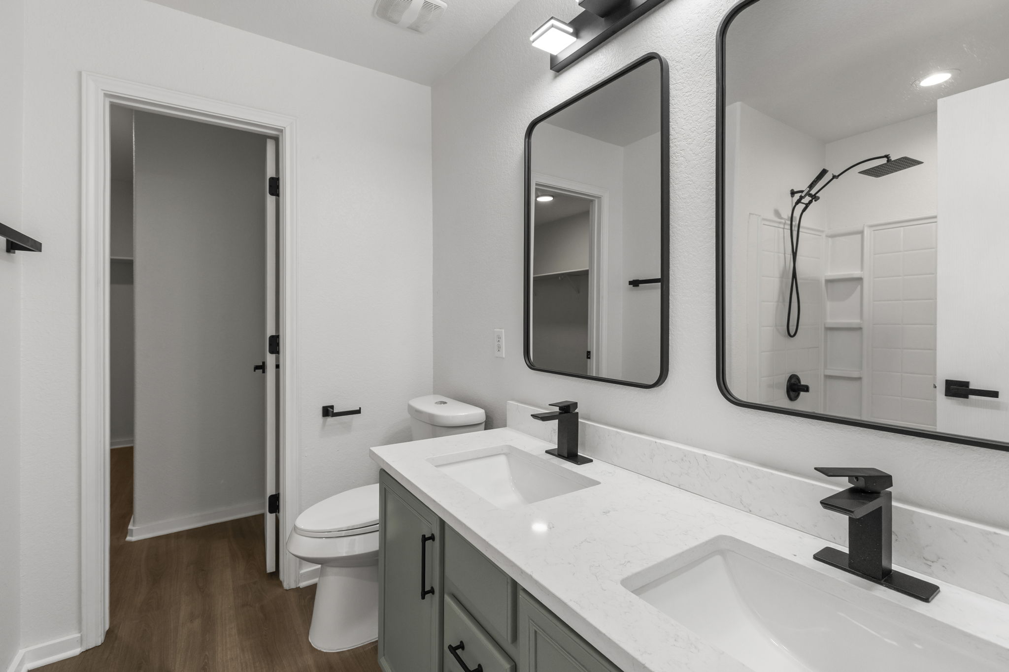 2110 Nogales Trail Austin, TX 78744 - Photo 23 of 36 Full bath with a shower, double vanity, and wood-type flooring