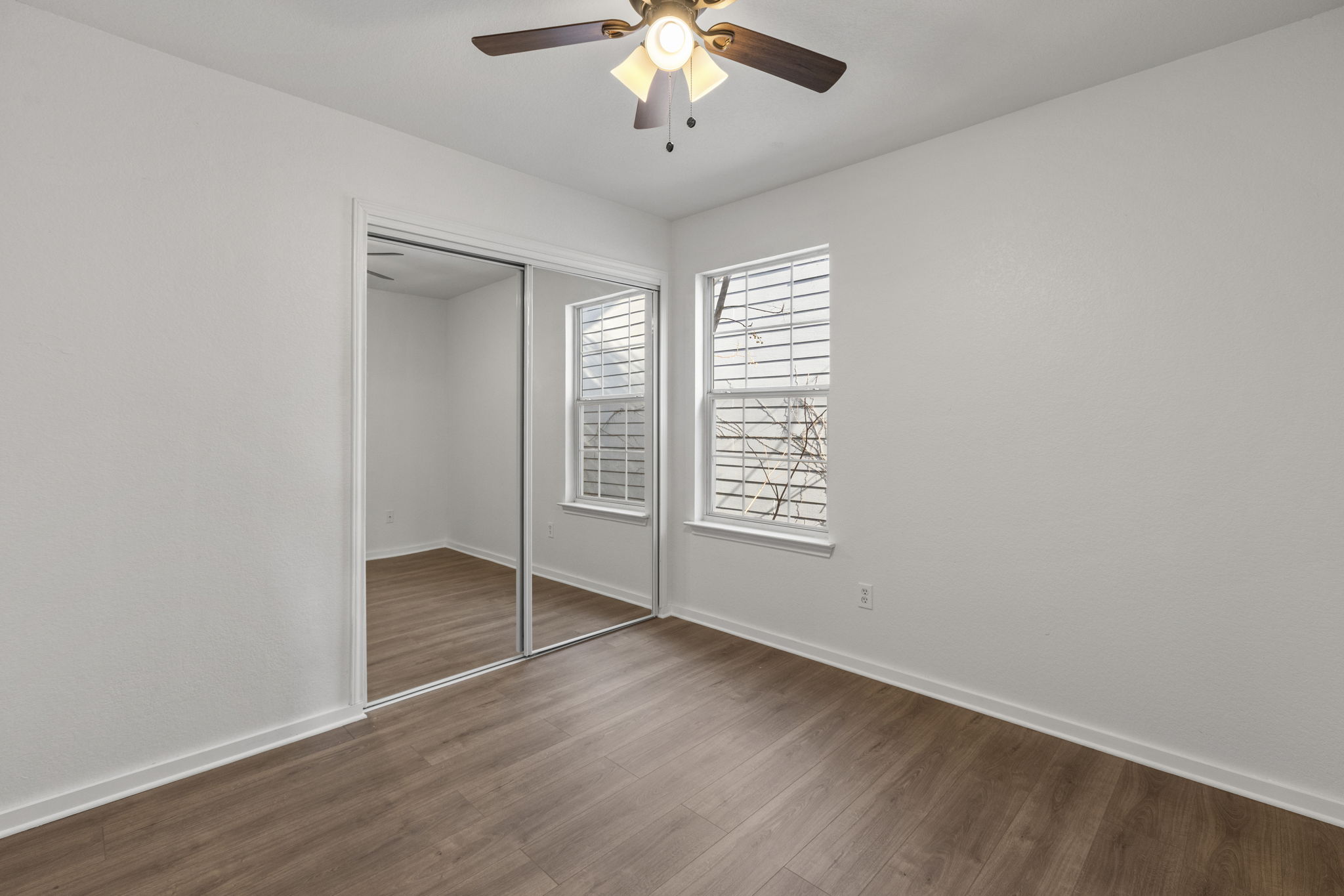 2110 Nogales Trail Austin, TX 78744 - Photo 29 of 36 Unfurnished bedroom featuring wood finished floors, a closet, and a ceiling fan
