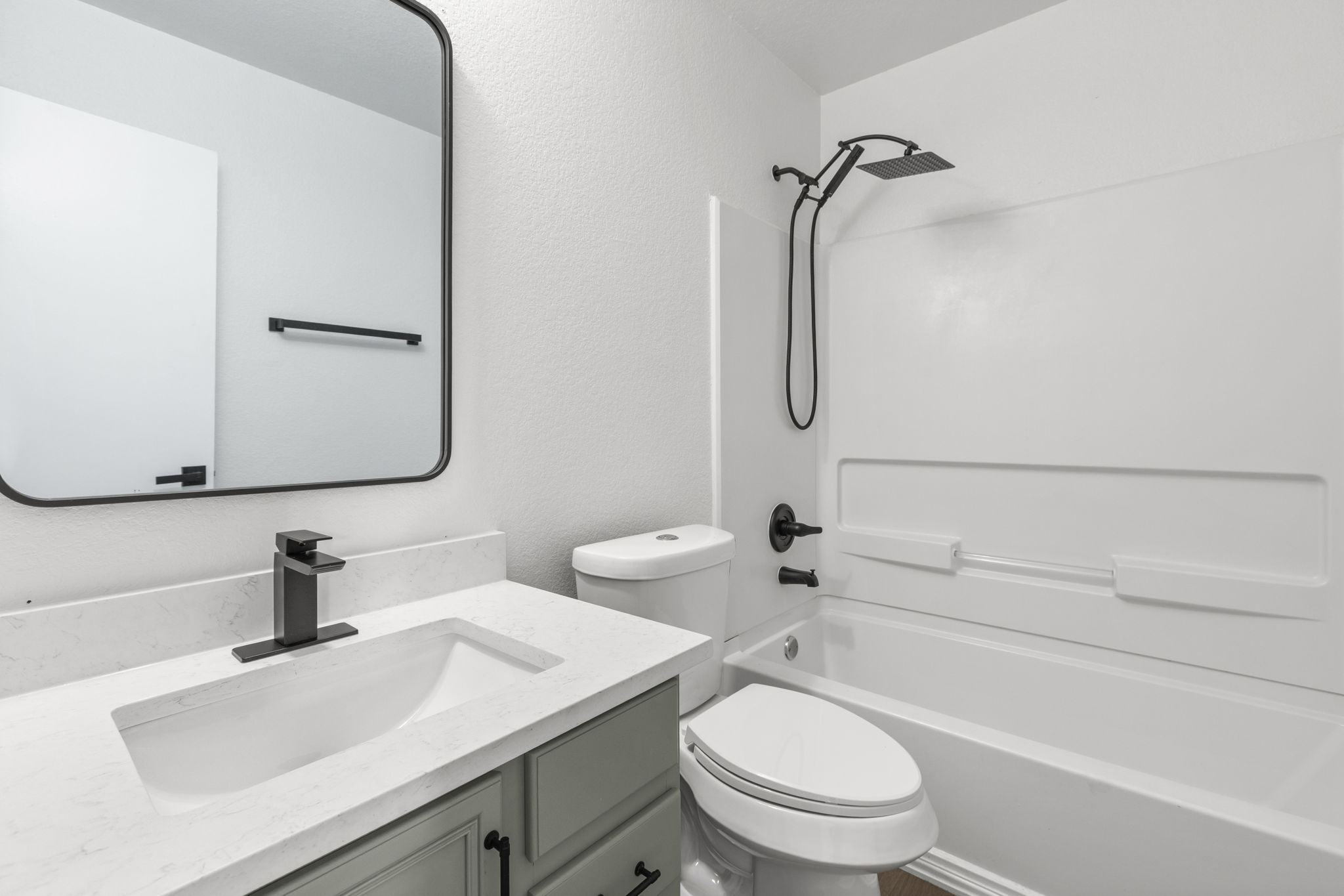 2110 Nogales Trail Austin, TX 78744 - Photo 31 of 36 Bathroom featuring shower / tub combination, a textured wall, and vanity