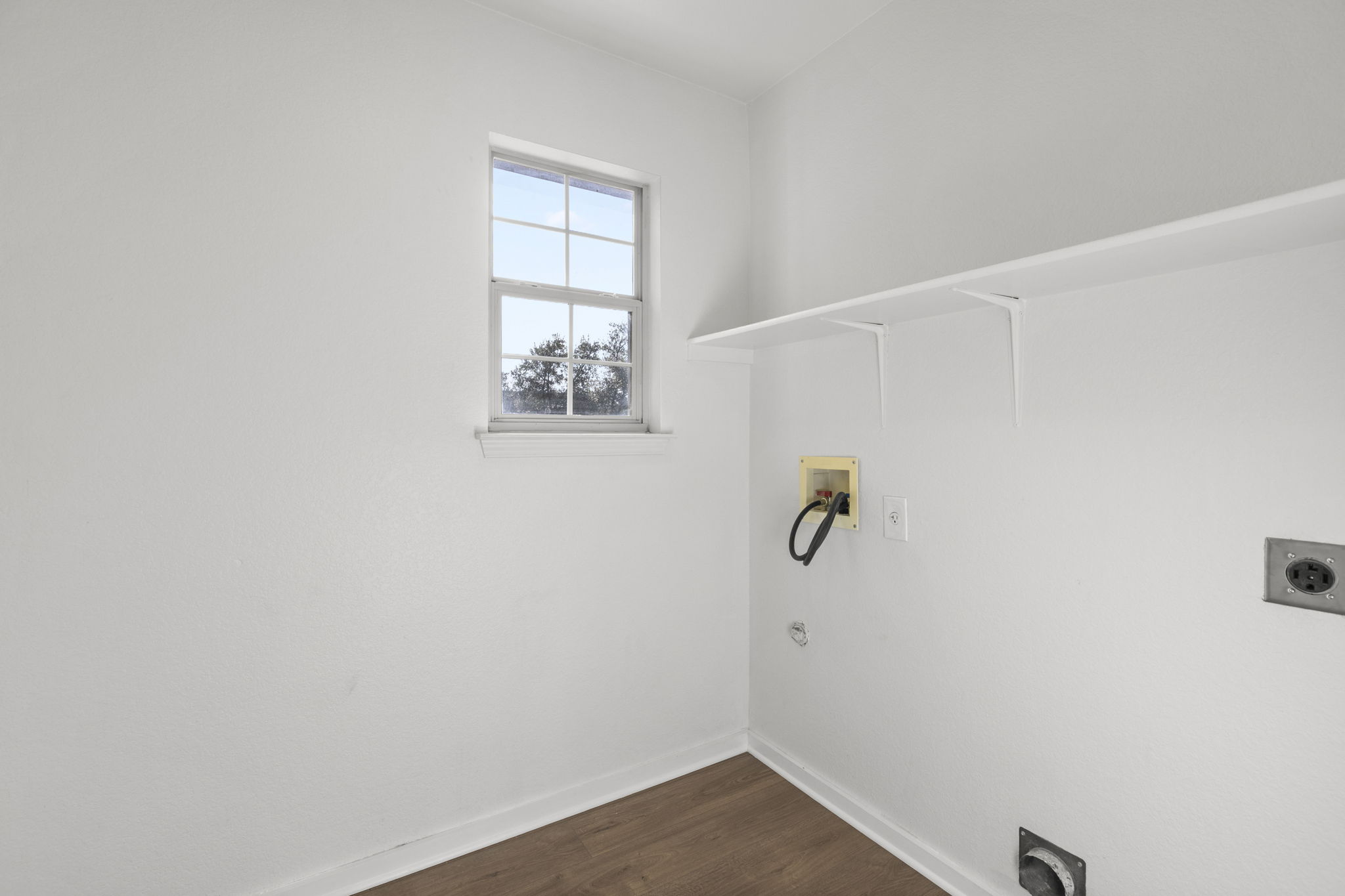 2110 Nogales Trail Austin, TX 78744 - Photo 32 of 36 Washroom with hookup for an electric dryer, dark wood-style flooring, and hookup for a washing machine