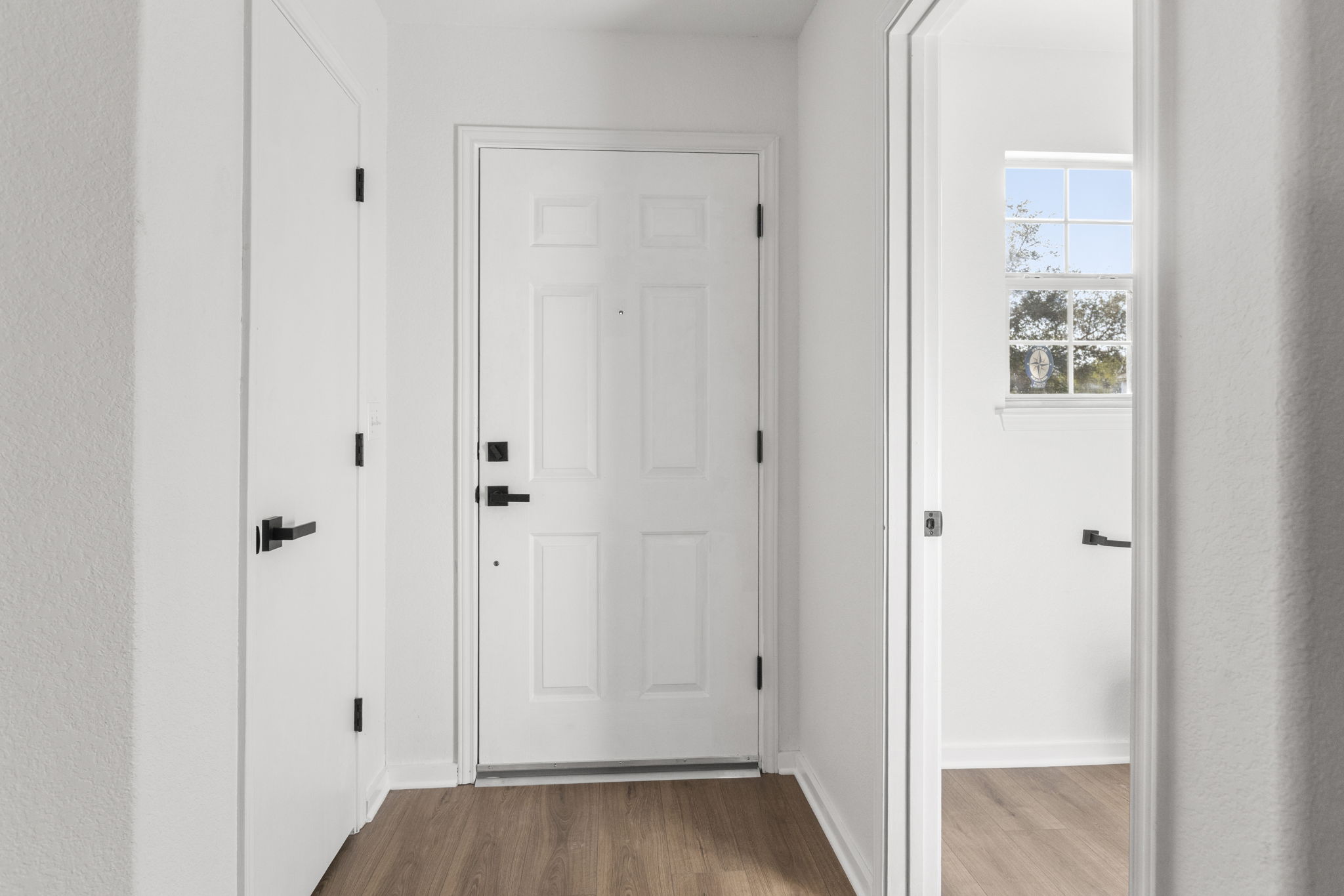 2110 Nogales Trail Austin, TX 78744 - Photo 33 of 36 Doorway to outside with wood finished floors and baseboards
