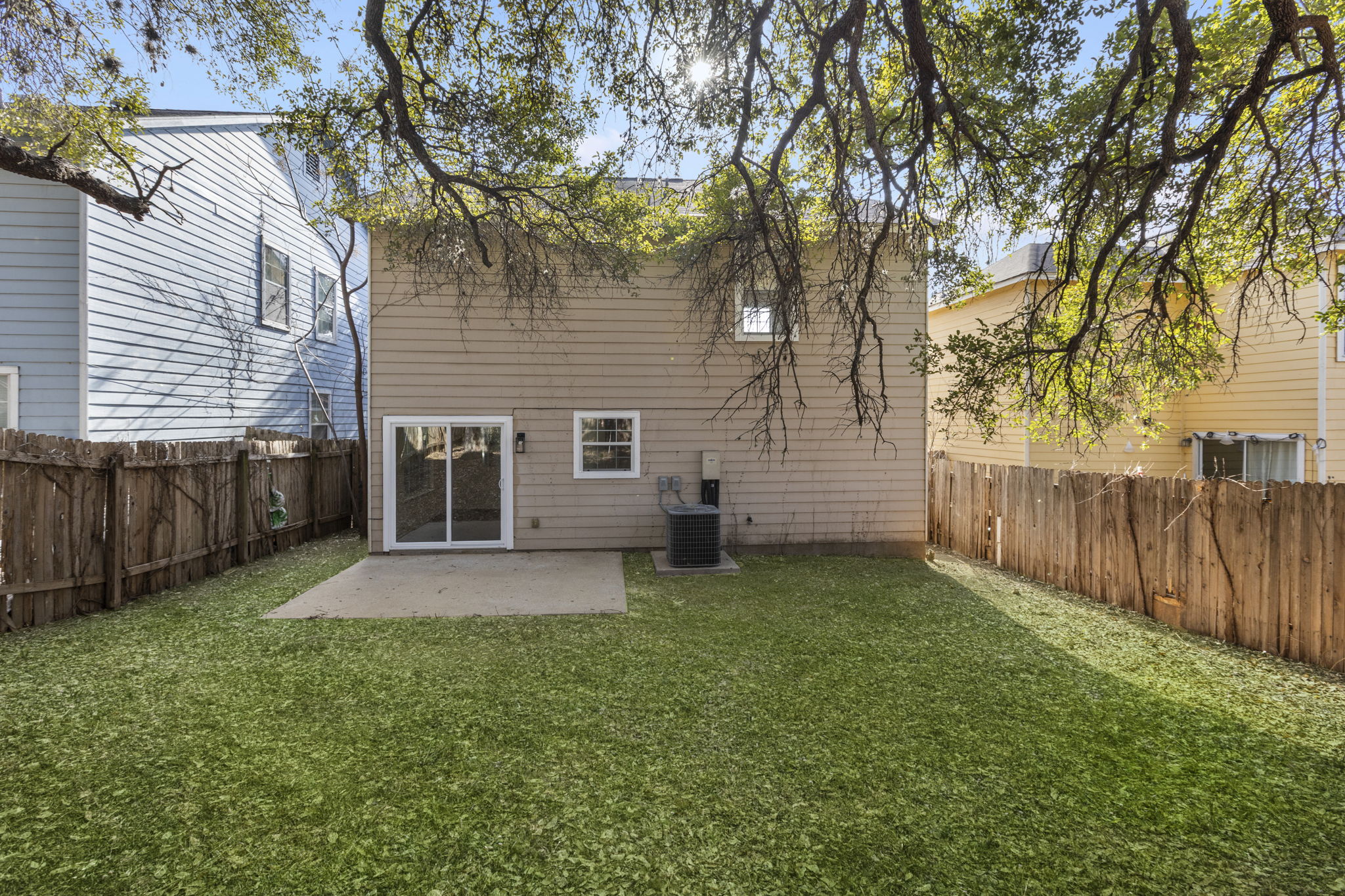 2110 Nogales Trail Austin, TX 78744 - Photo 34 of 36 Rear view of house with a patio and a fenced backyard. Virtual grass.