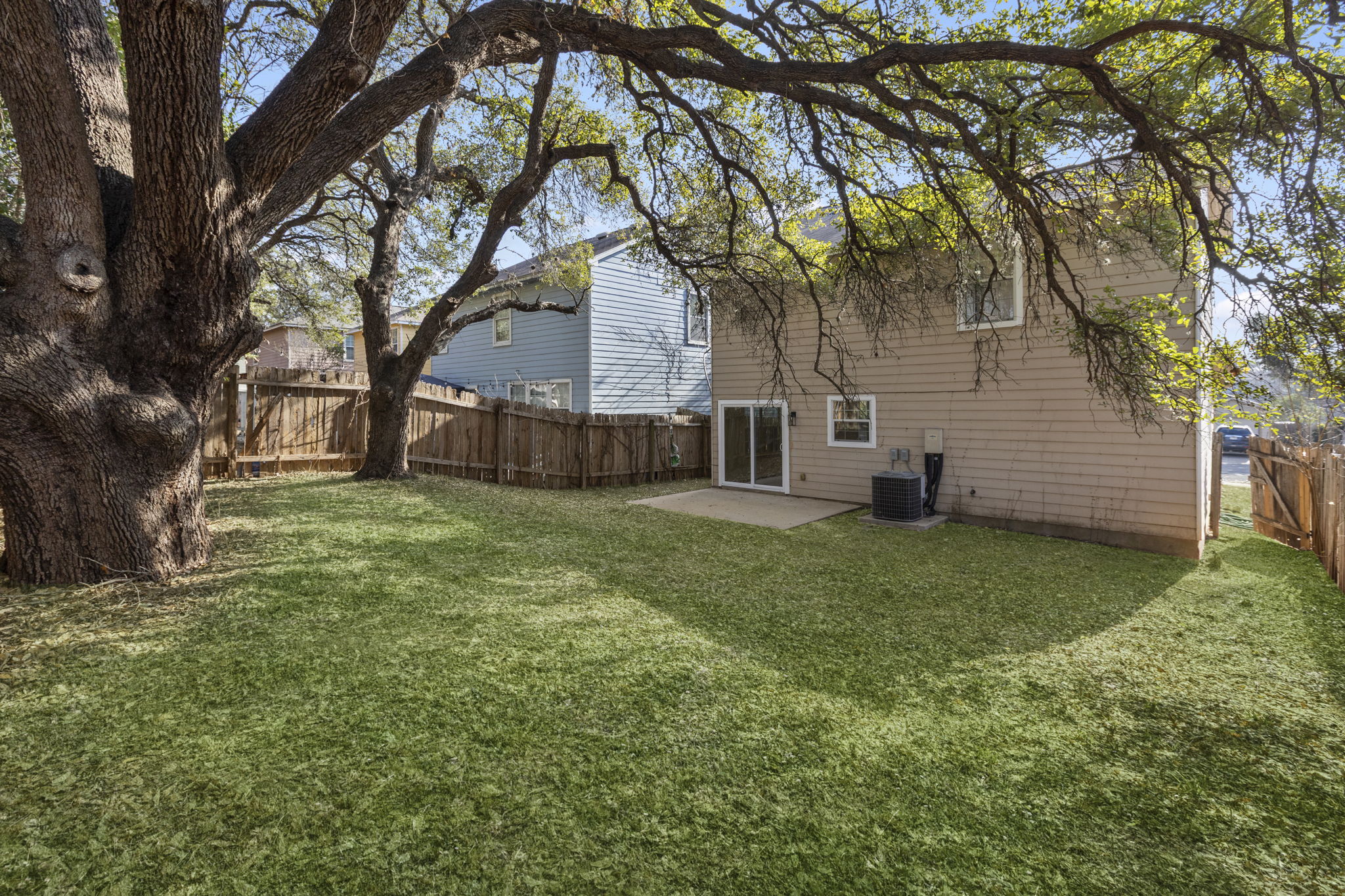 2110 Nogales Trail Austin, TX 78744 - Photo 35 of 36 Back of house with a patio and a fenced backyard. Virtual grass.